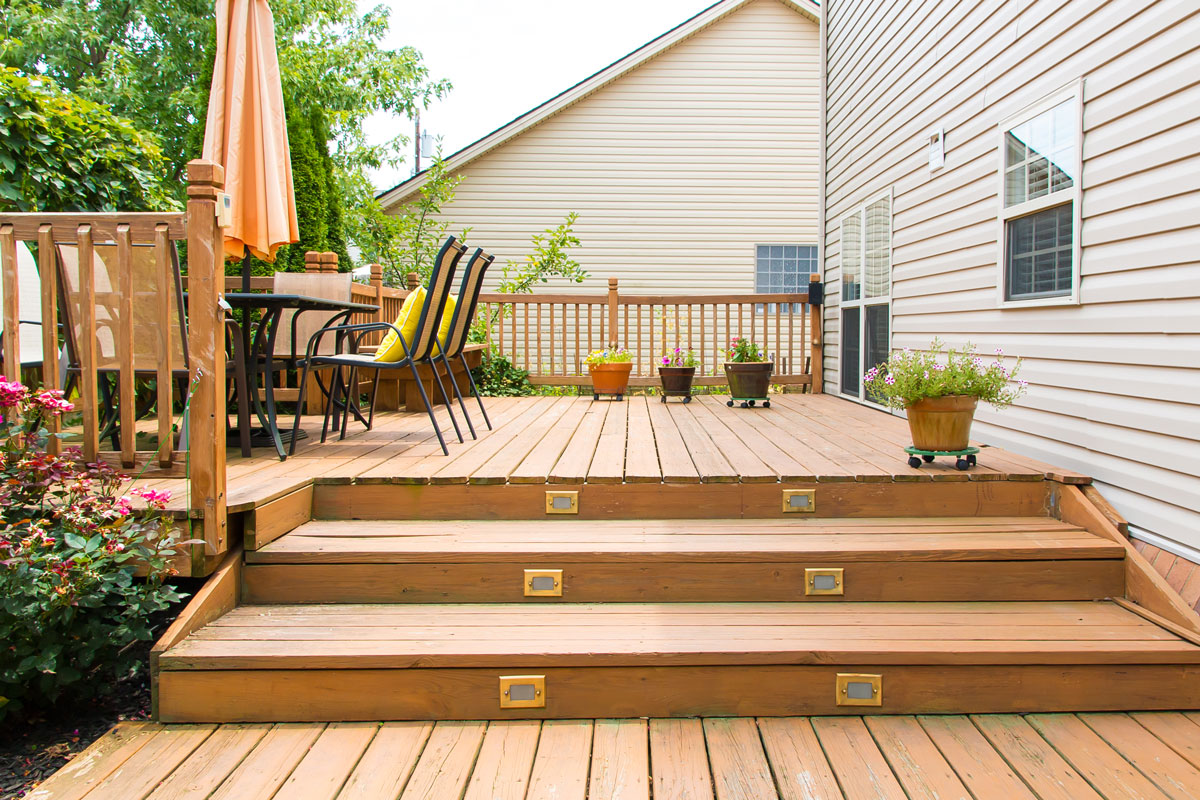 A gorgeous wooden deck on the backyard of a house