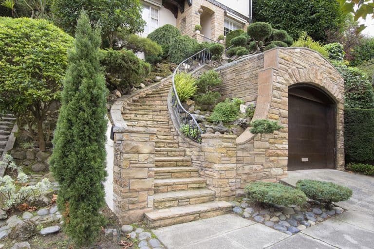 A huge mansion with stone veneer on the garage and staircase leading to the main door, How High Should Stone Veneer Be?