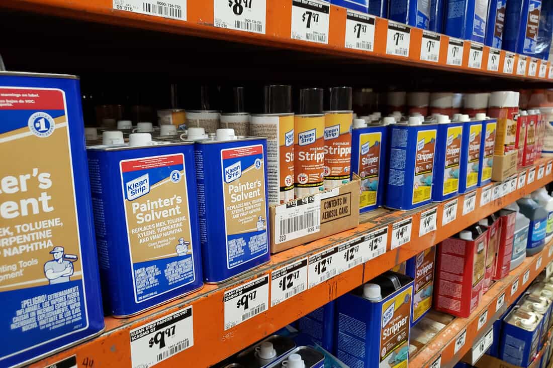 A view of several containers of Klean Strip painter's solvent and other paint removal products, on display at a local home improvement store.