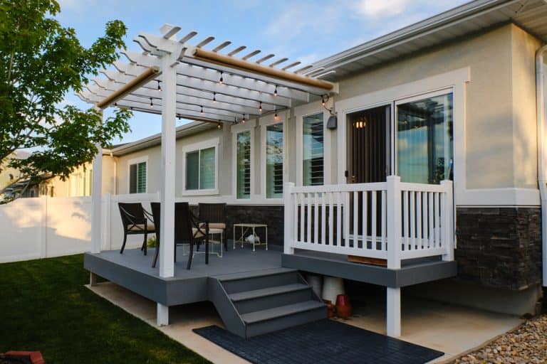 A backyard of a suburban home with a deck and pergola, 15 Great White And Gray Deck Ideas