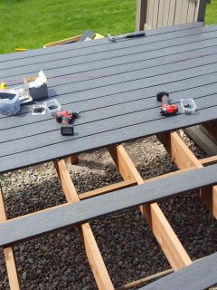 Constructing a black wooden deck at the backyard, 12 Types Of Decking Boards, Materials And Layouts