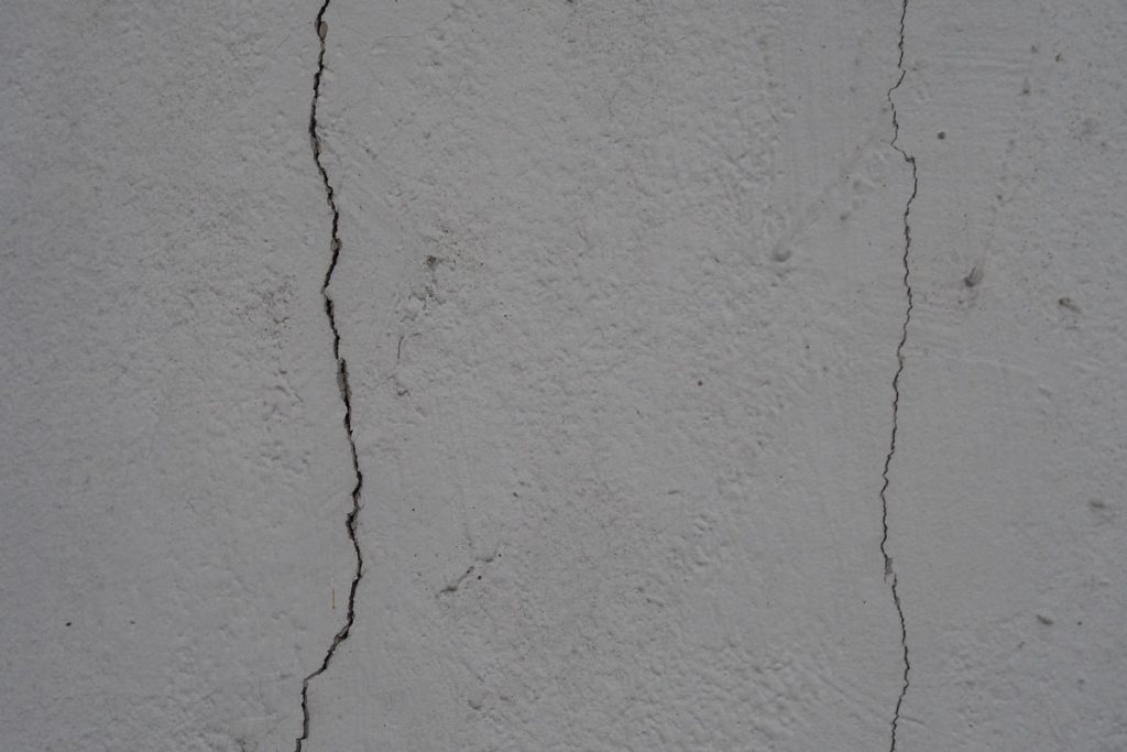 Crack on cement wall bare polished grey color and smooth surface texture