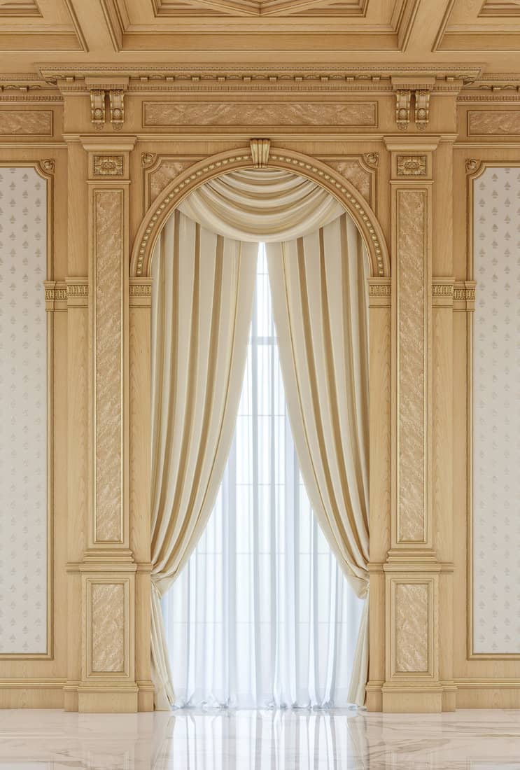 Curtains in a carved niche of wood in a classic style with a wooden ceiling.