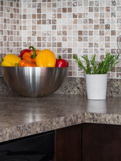 Food ingredients and herbs on granite kitchen countertop, How Much Does Granite Weigh? [Countertops Explored]