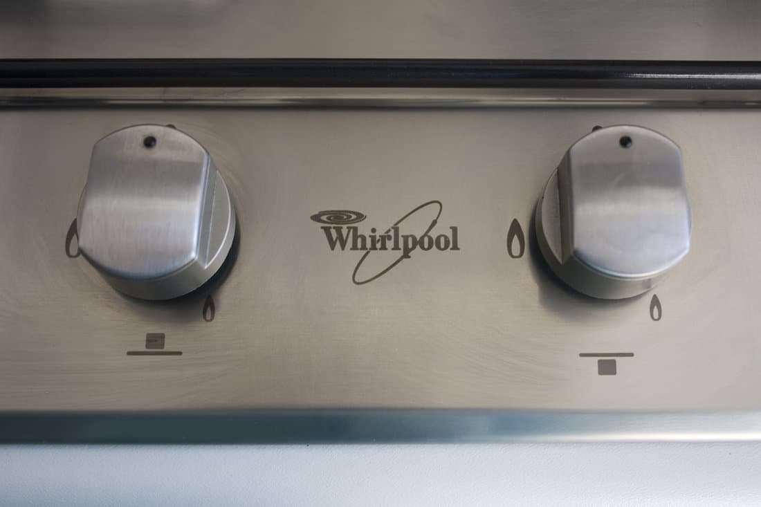 Fragment of metal gas stove «Whirpool» on modern kitchen