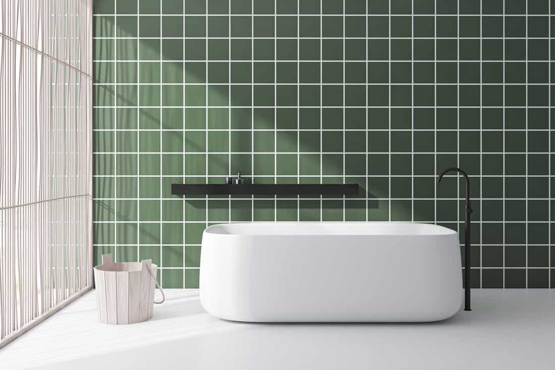 Green tile bathroom interior with tub — Photo