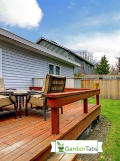 Grey small house with simple deck and outdoor chairs, Do Decks Have To Be Attached To The House?