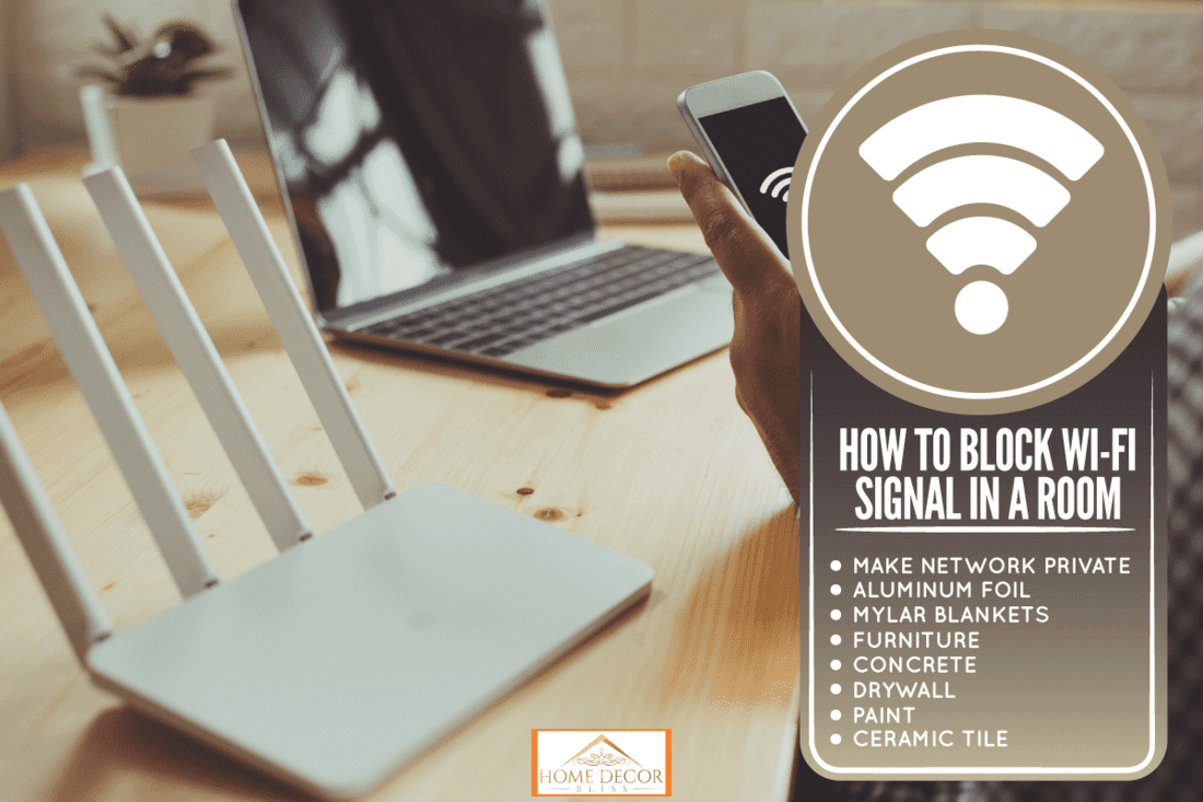 a wifi router and a man using smartphone on living room at home ofiice, How To Block Wi-Fi Signal In A Room?