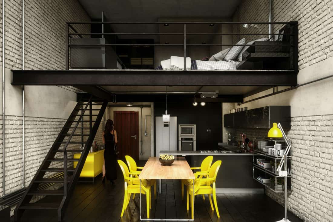 Industrial themed loft apartment with white decorative brick on the walls matched with bright yellow dining set