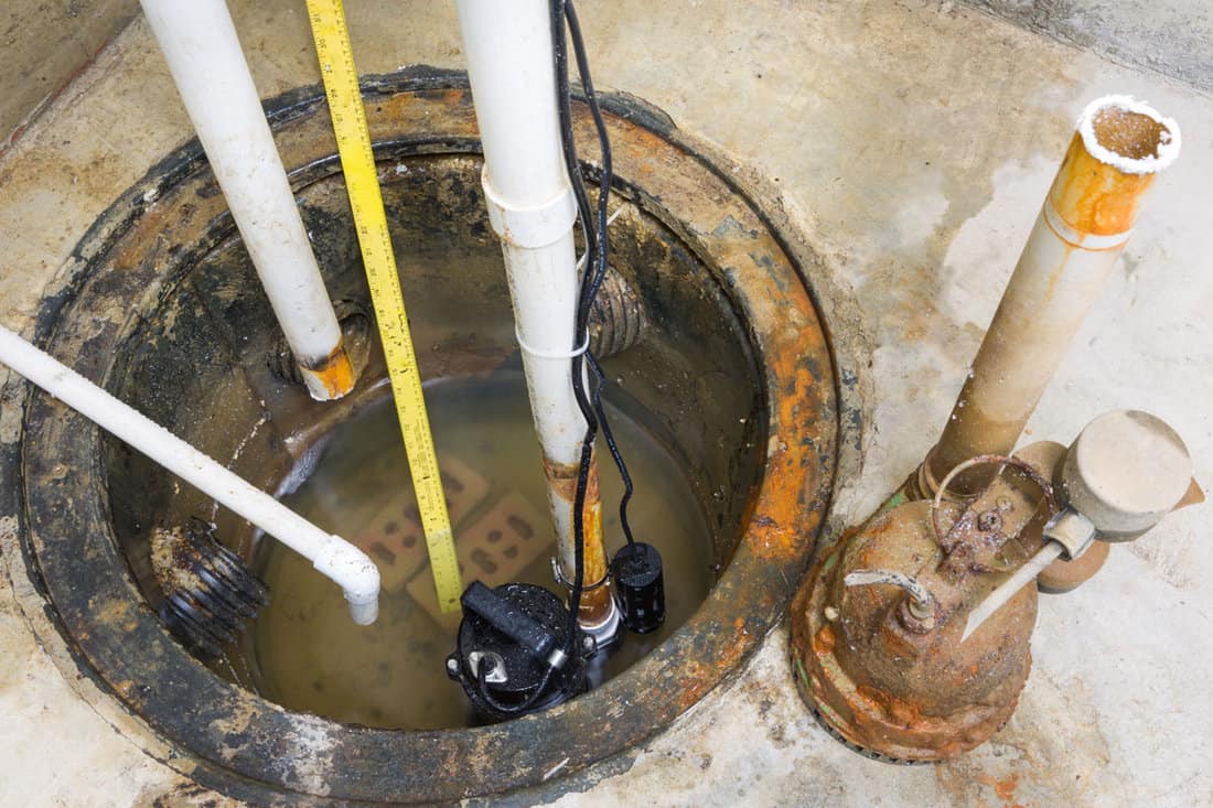 Installation of a new sump pump and the removal of the old obsolete rusty one
