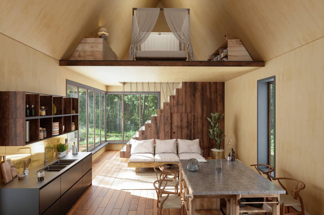 Interior of a contemporary themed house with a loft bed and matching wooden flooring, wooden furnitures and beige ceiling
