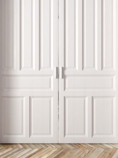 Interior of a room with classic white double sliding raised doors against blue wall, How To Paint Trim Without Brush Marks