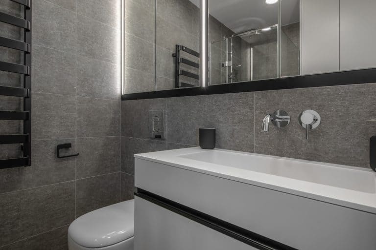 Interior of an ultra gray themed bathroom with white tiled vanity and a huge long span mirror, What Color Shower Curtain For A Gray Bathroom?