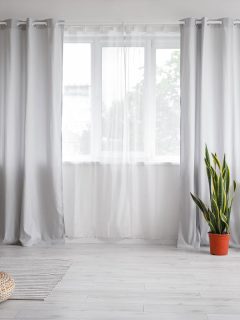 Interior of modern room with light curtains, How To Hang Curtains With Different Height Windows?