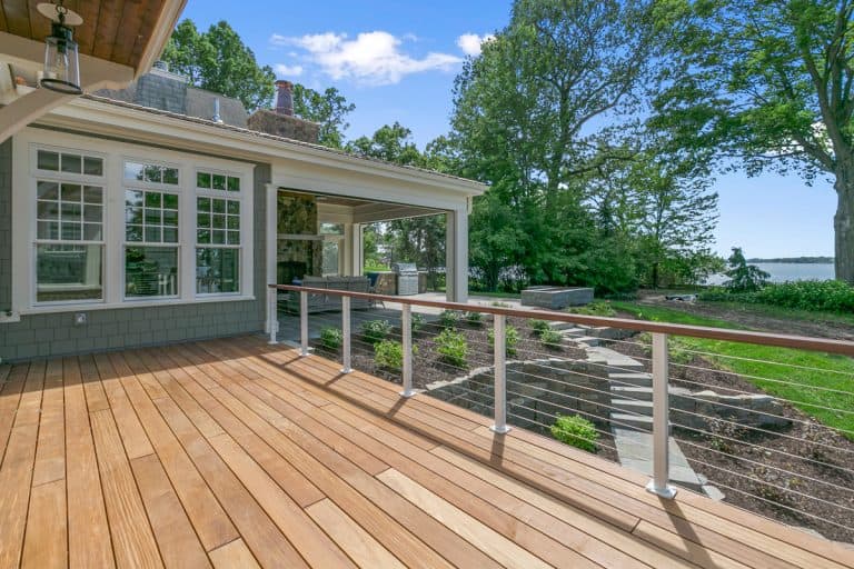 Lakeside luxury home with large wood deck and beautifully landscaped yard, Should You Power Wash A Wooden Deck? [And How To]