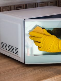 A man cleaning microwave, How To Remove Scratches From Microwave Door