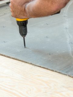 Man installing cement board to the subfloor, Can You Walk On Cement Board?