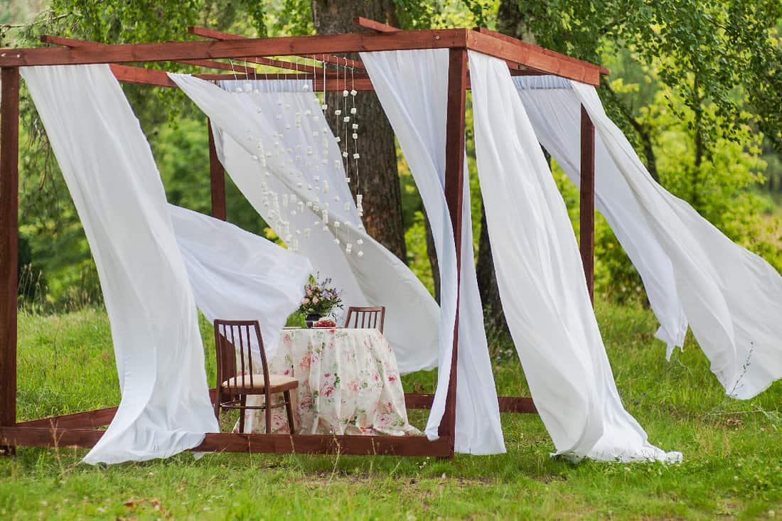Outdoor gazebo with white curtains