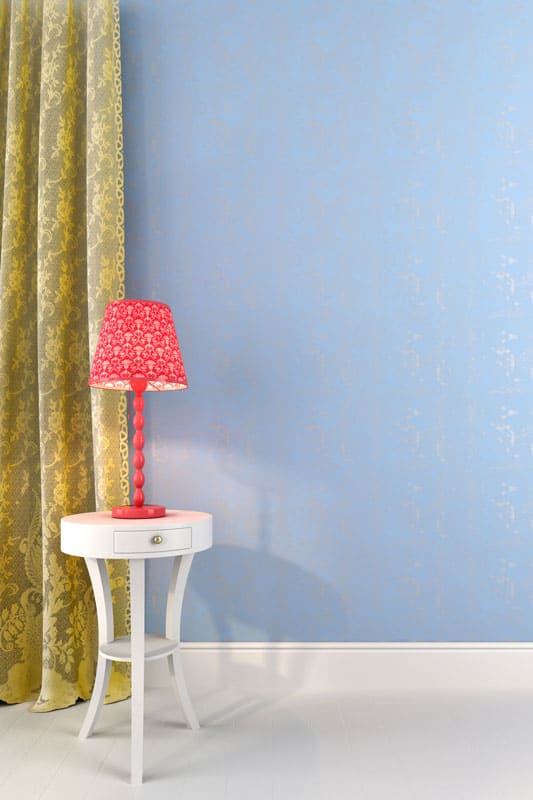 Pink desk lamp against a light blue wall