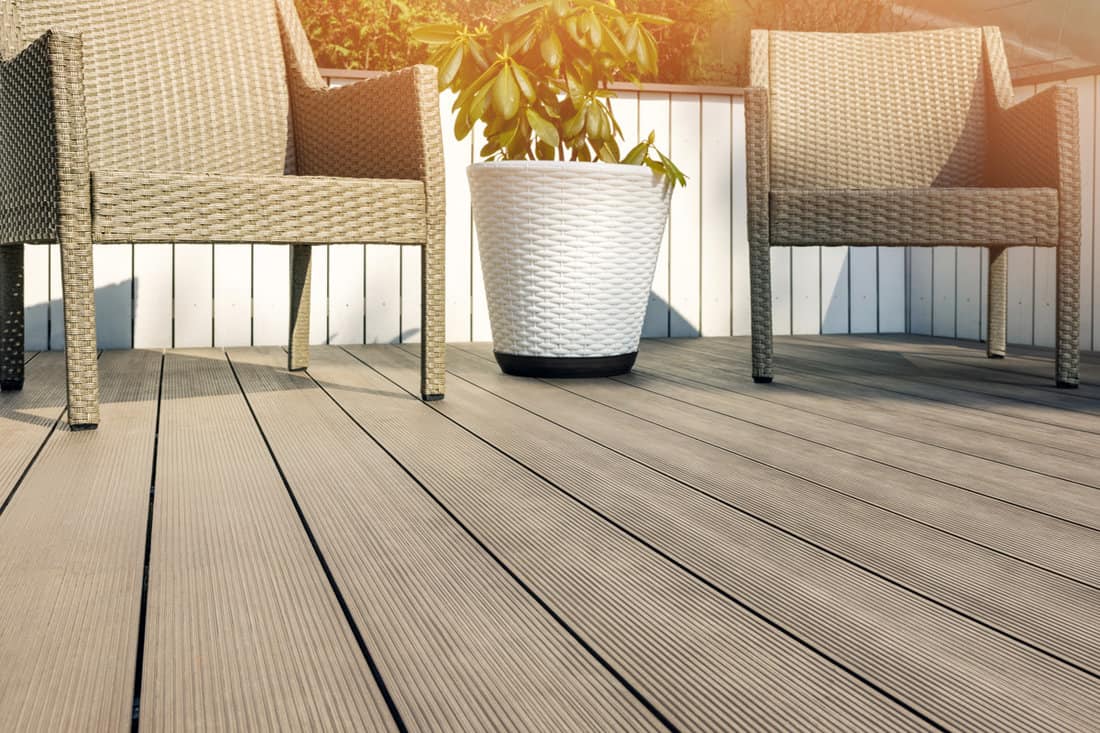 Plastic wicker chairs placed on the wooden deck