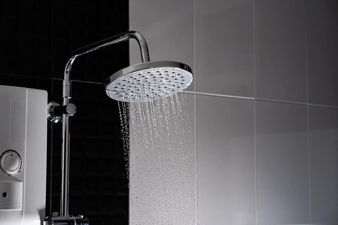 Rain shower head pouring clean water in the shower
