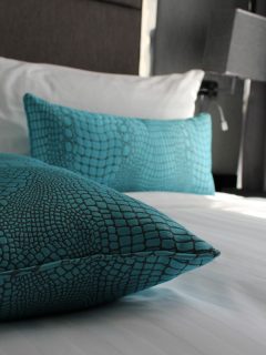 Turquoise color pillows inside a dark gray themed bedroom, 15 Wall Decor Ideas For A Masculine Bedroom Or Den