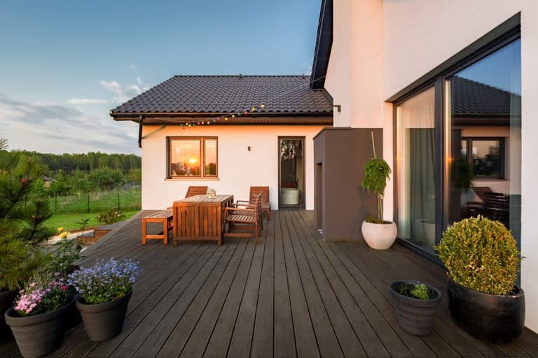 Cozy villa patio with decorative plants and wooden flooring, 5 Best Sealers For Your Wood Deck