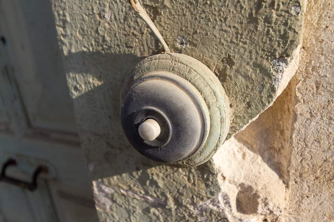 Vintage doorbell on an old abandoned house