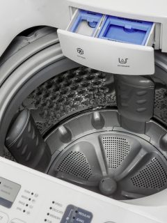 Washing Machine Isolated on White. Major Domestic and Bathroom Appliances top View. Home Innovations. Modern White and Steel Front Load Washer Machine with Electronic Control Panel - Why Does My Top Loader Washing Machine Stink