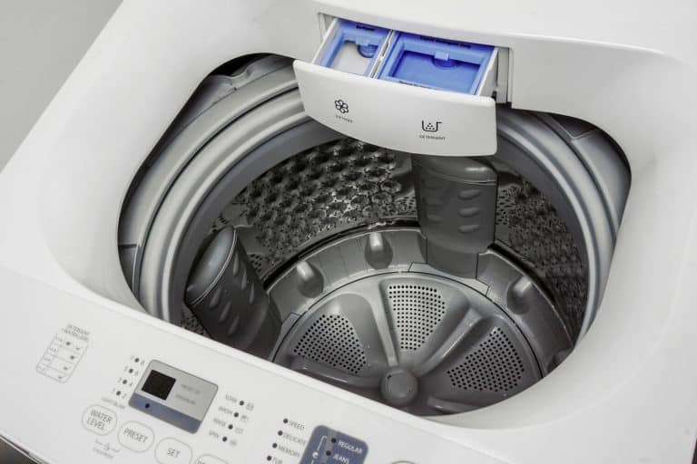 Washing Machine Isolated on White. Major Domestic and Bathroom Appliances top View. Home Innovations. Modern White and Steel Front Load Washer Machine with Electronic Control Panel - Why Does My Top Loader Washing Machine Stink
