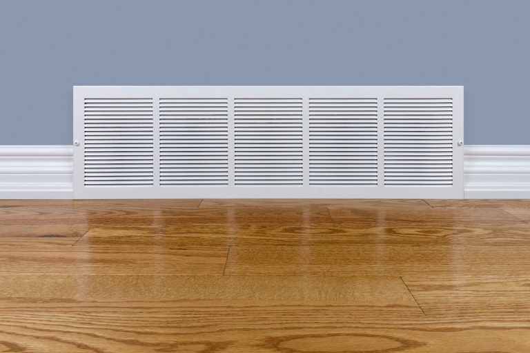 Wall cold air return grille sitting on hardwood floor - Should Every Room Have A Return Vent