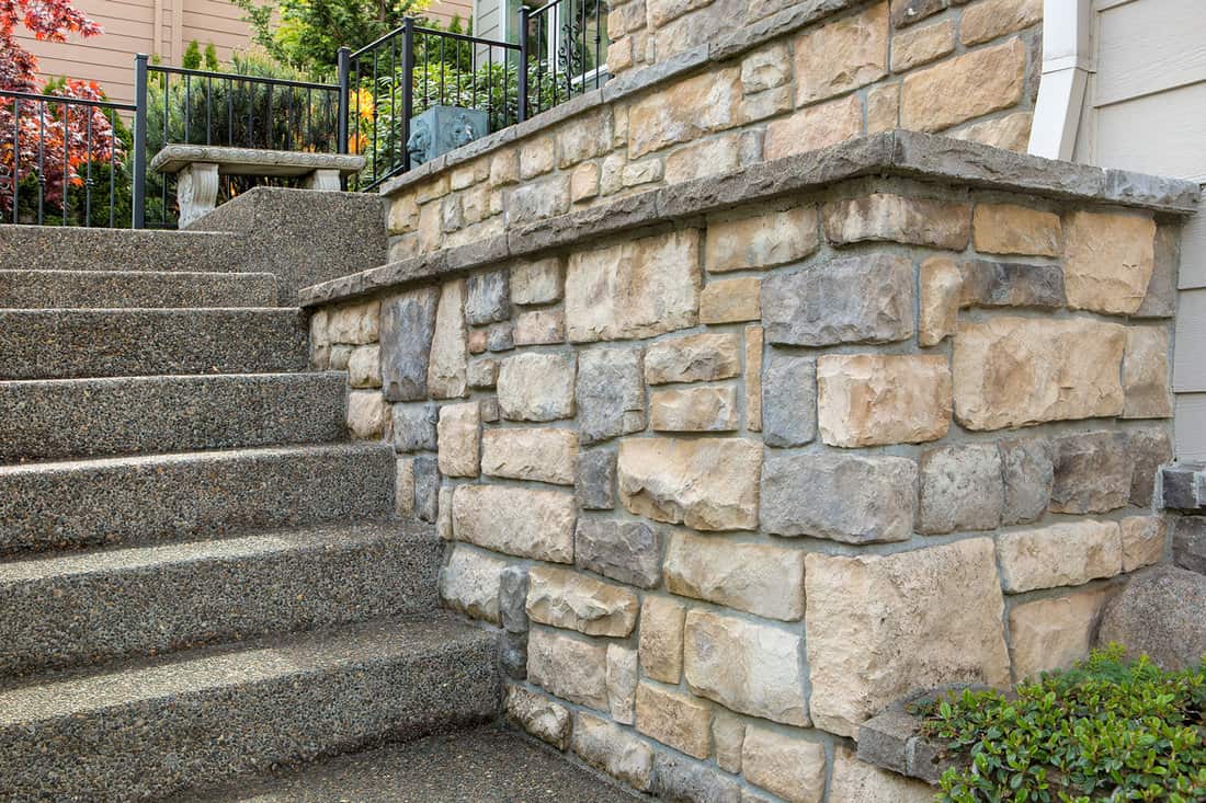 Wash out pebble stairs and stone veneer decorated on the wall