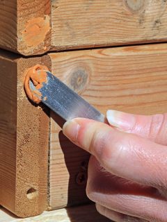 Wood Filler Being Applied To Holes By A Female Carpenter Ready For Sanding Down, Can You Use Wood Filler Outside [And Which One To Choose]?
