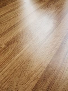 Wood laminated floor texture with reflection light, How Long Does Laminate Flooring Last? [Inc. Pergo]