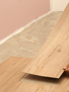 Worker installing new vinyl tile floor, How To Match Vinyl Flooring When Making A Repair