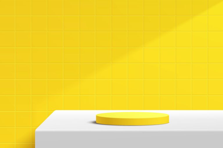 a photo of a yellow tile on the wall, white table, yellow plate on the white table, What Color Goes With Yellow Tile?