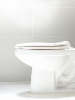 clean toilet, white toilet bowl, white floor tiles, white walls, How To Remove Metal Scratches From Toilet Bowl