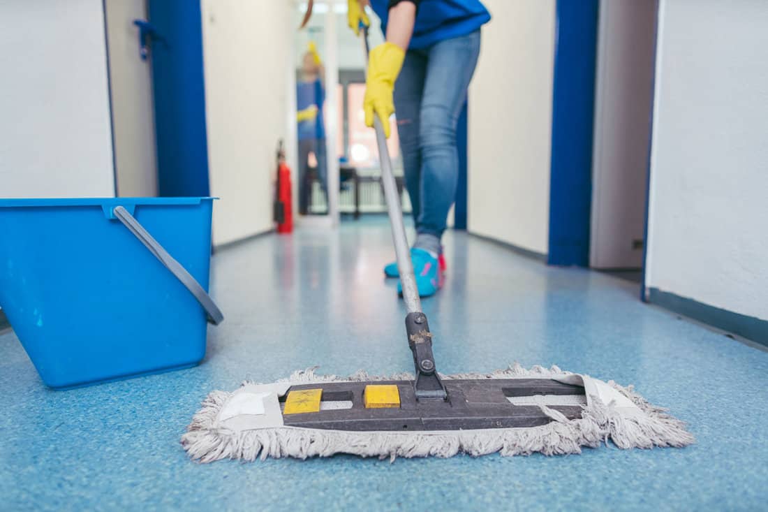 cleaners moping the floor of a hall