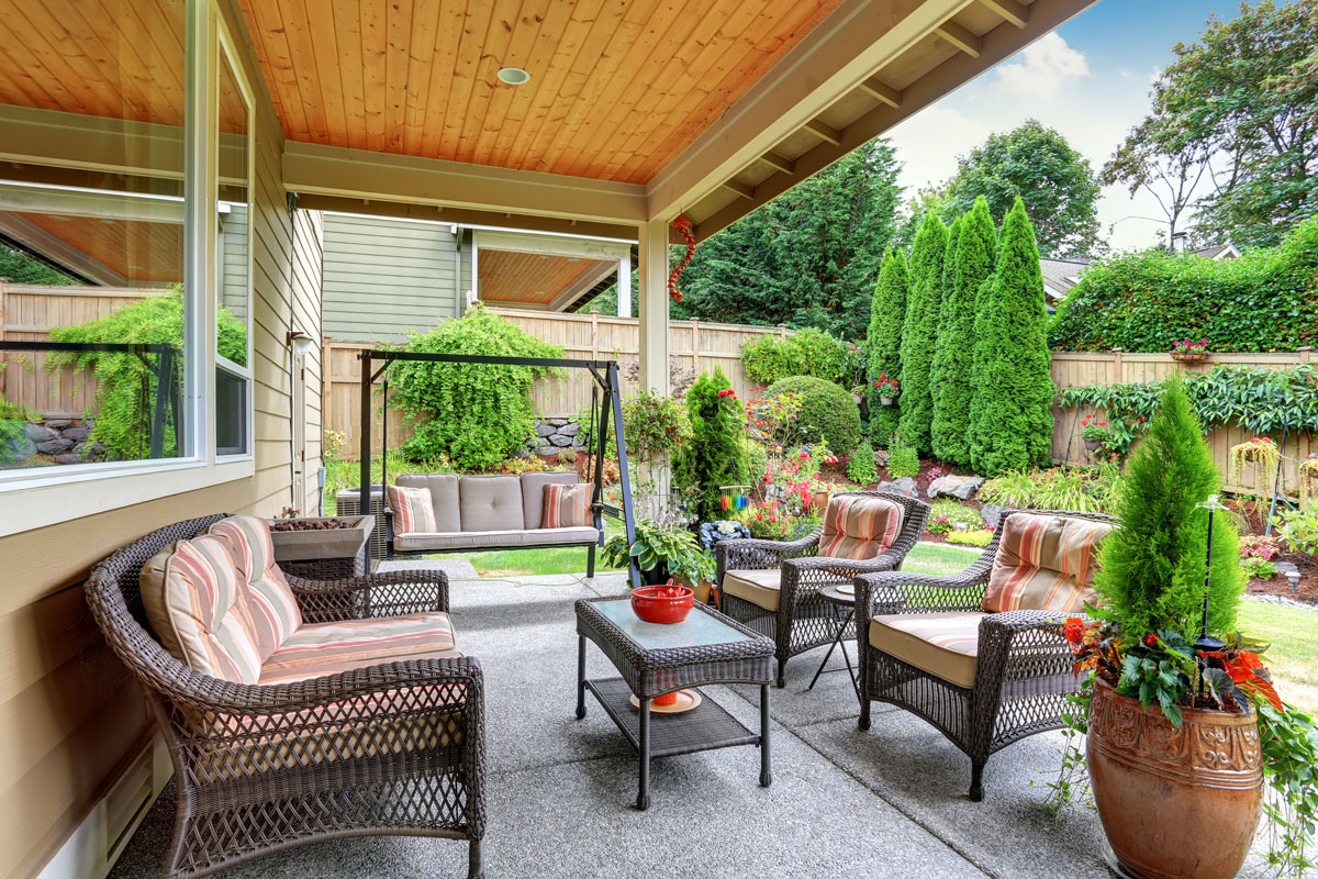 nice view of garden, outdoor sofa set, outdoor center table, plants on pots, green garden grass