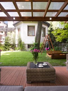 outdoor photo, green garden grass, outdoor sofa, outdoor center table, swing, clear roof