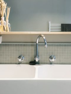 photo of a bathroom sink, wide white ceramic bathroom sink, silver faucet, How Close Can Outlet Be To Toilet?