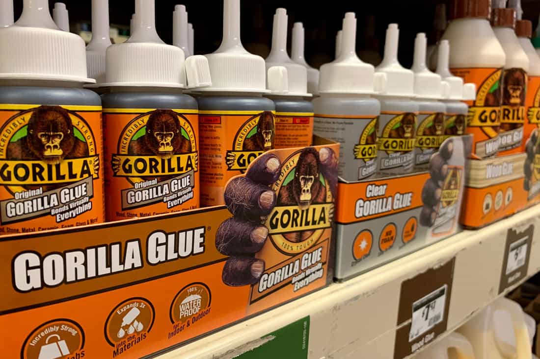 photo of a gorilla glue on the store shelves for display, orange, white, design