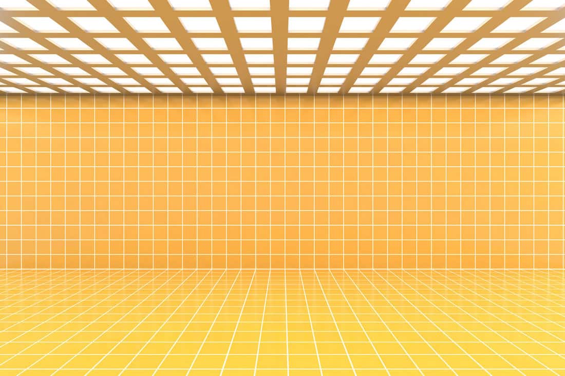 photo of an empty room with yellow wall tile, and yellow floor tile, checkered ceiling