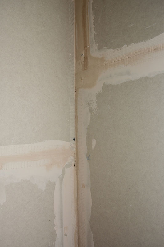 A close-up on a drywall corner finishing, plastering, coating with drywall tape or self-adhesive