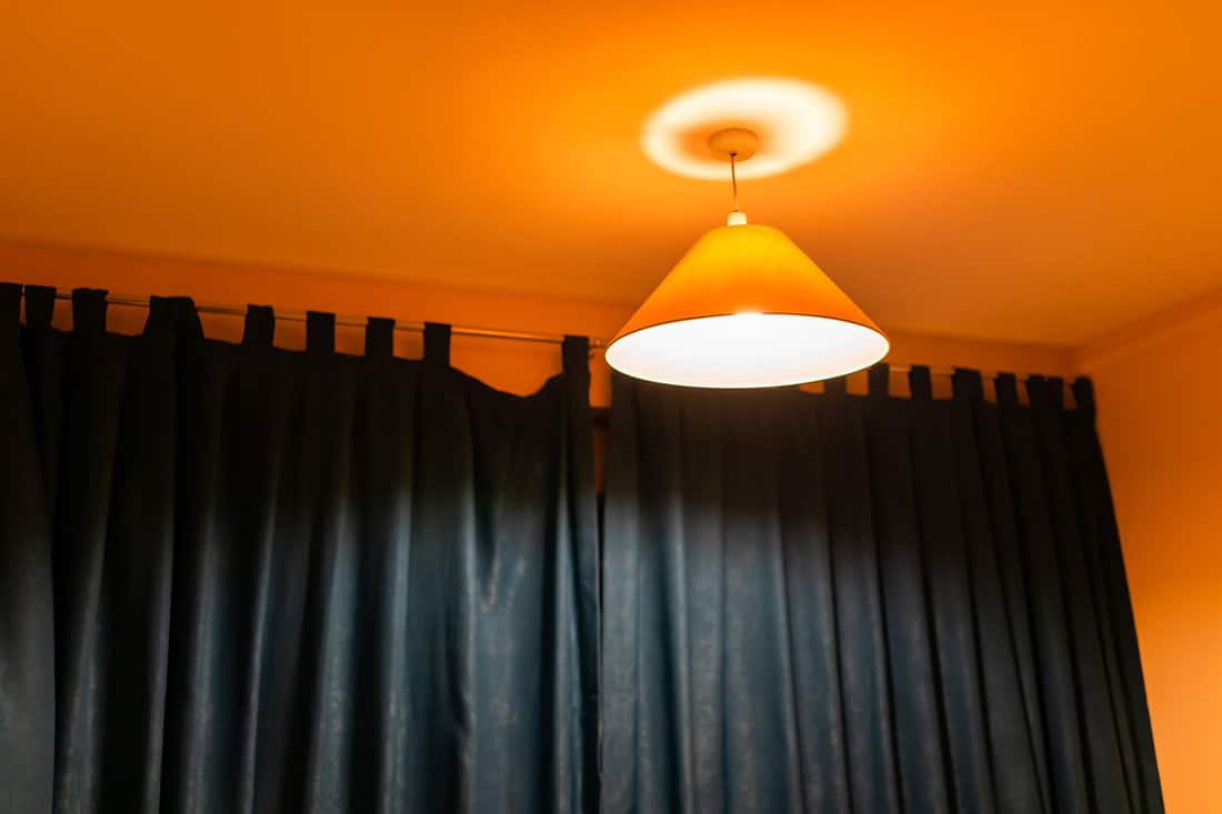 A huge black curtain inside an orange living room