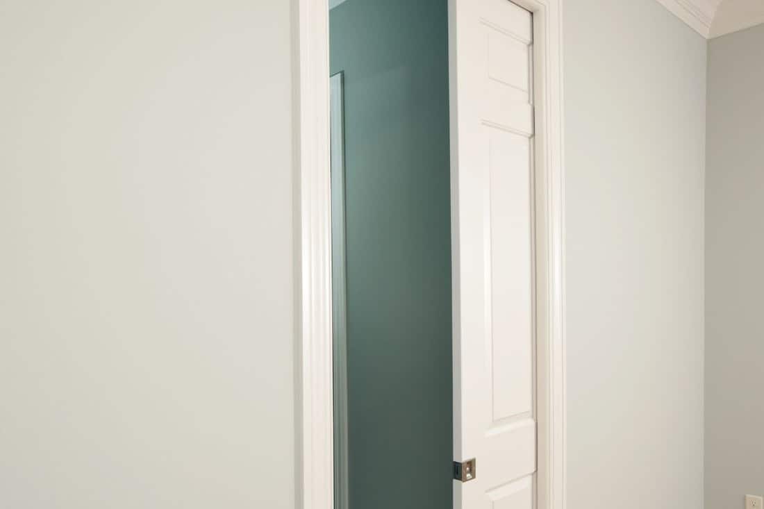 A new pocket door in a house bedroom entrance to bathroom. A pocket door saves space by sliding into the wall rather than swinging open.