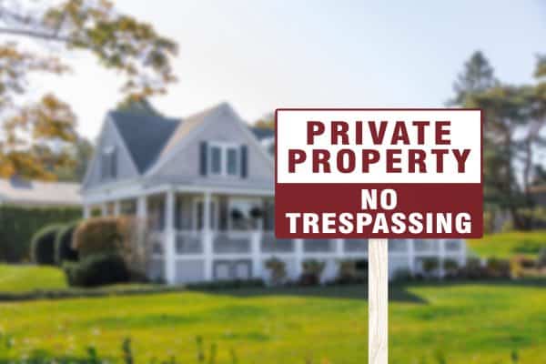A sign warning private property and no trespassing in front of a luxury home. A cautionary signage - How Far Apart Should No Trespassing Signs Be
