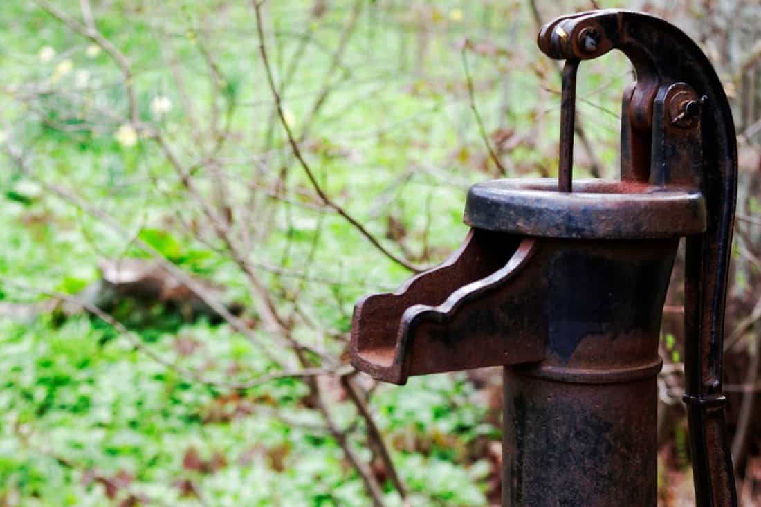 An antique hand water pump or pitcher pump