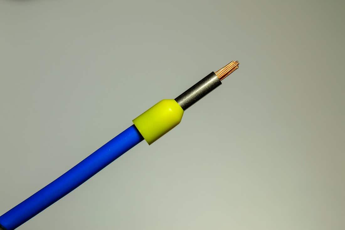 Blue wire with yellow ferrule - macro photo. Background picture. Selective focus.