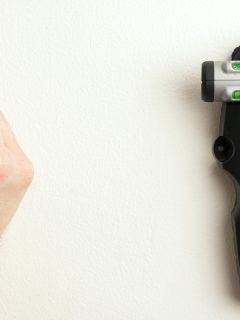 Carpenter marking the wall where a stud is placed, How To Use A Stanley Stud Finder [Step By Step Guide]